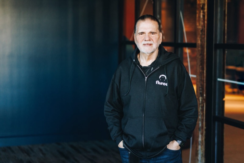 Flip Filipowski standing indoors in a black Fluree jacket