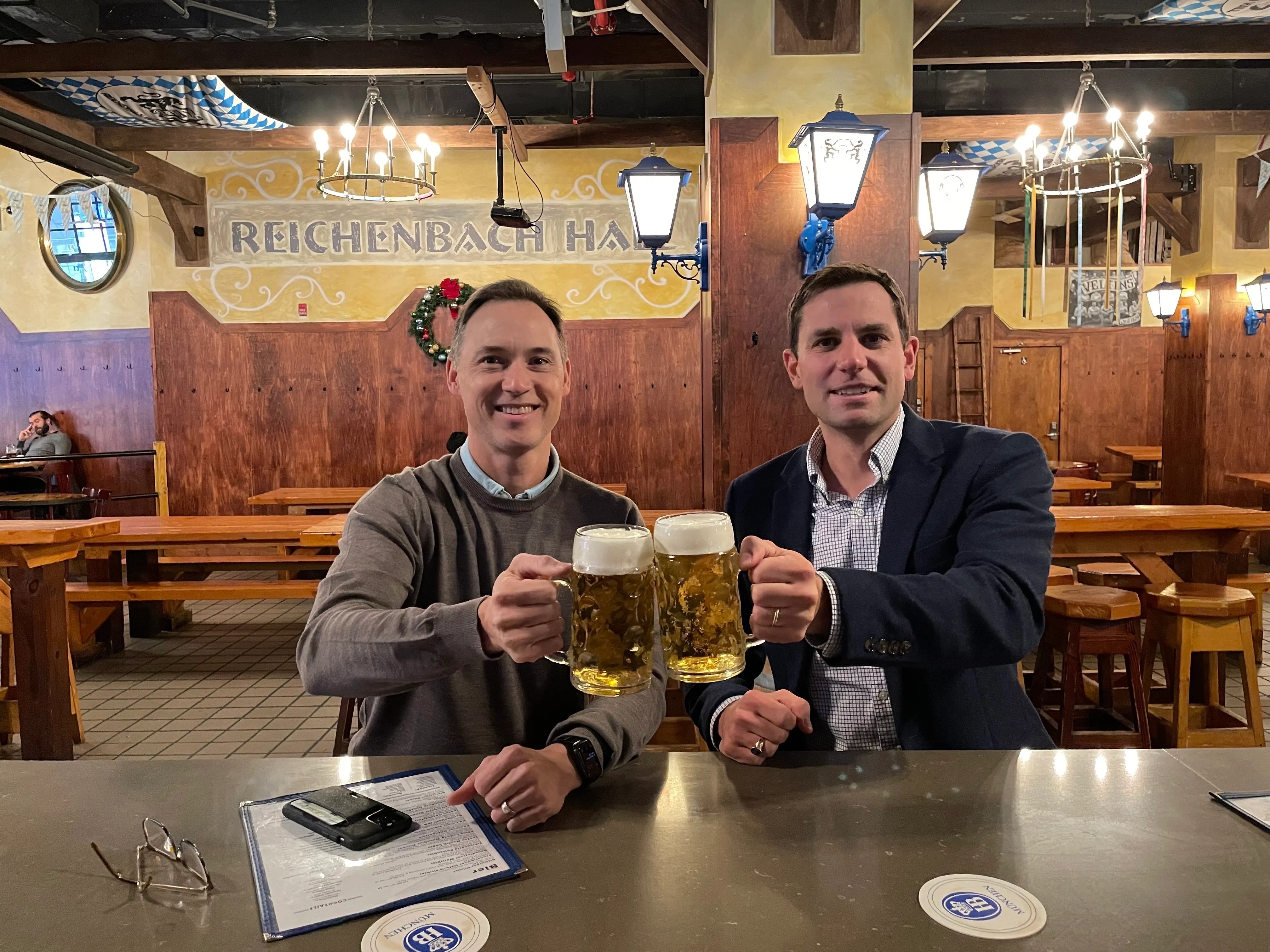 Mogl co-founders Andrew Fischer and Martin Skotnicki raising beer steins at a German beer hall