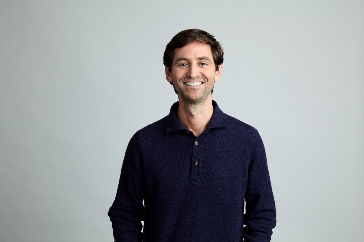 Andrew Grauer smiling in a navy shirt