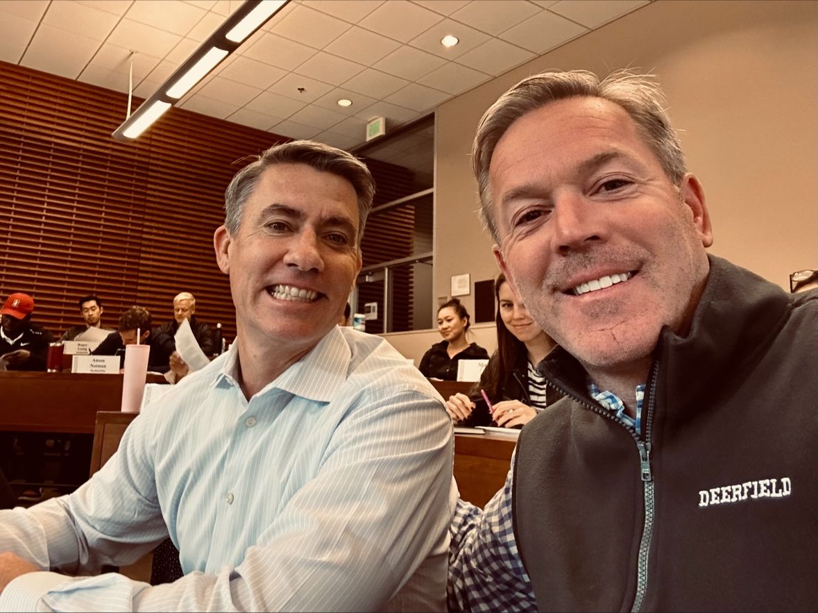 Andrew Housser, left, and Brad Stroh sitting in a Stanford Graduate School of Business classroom