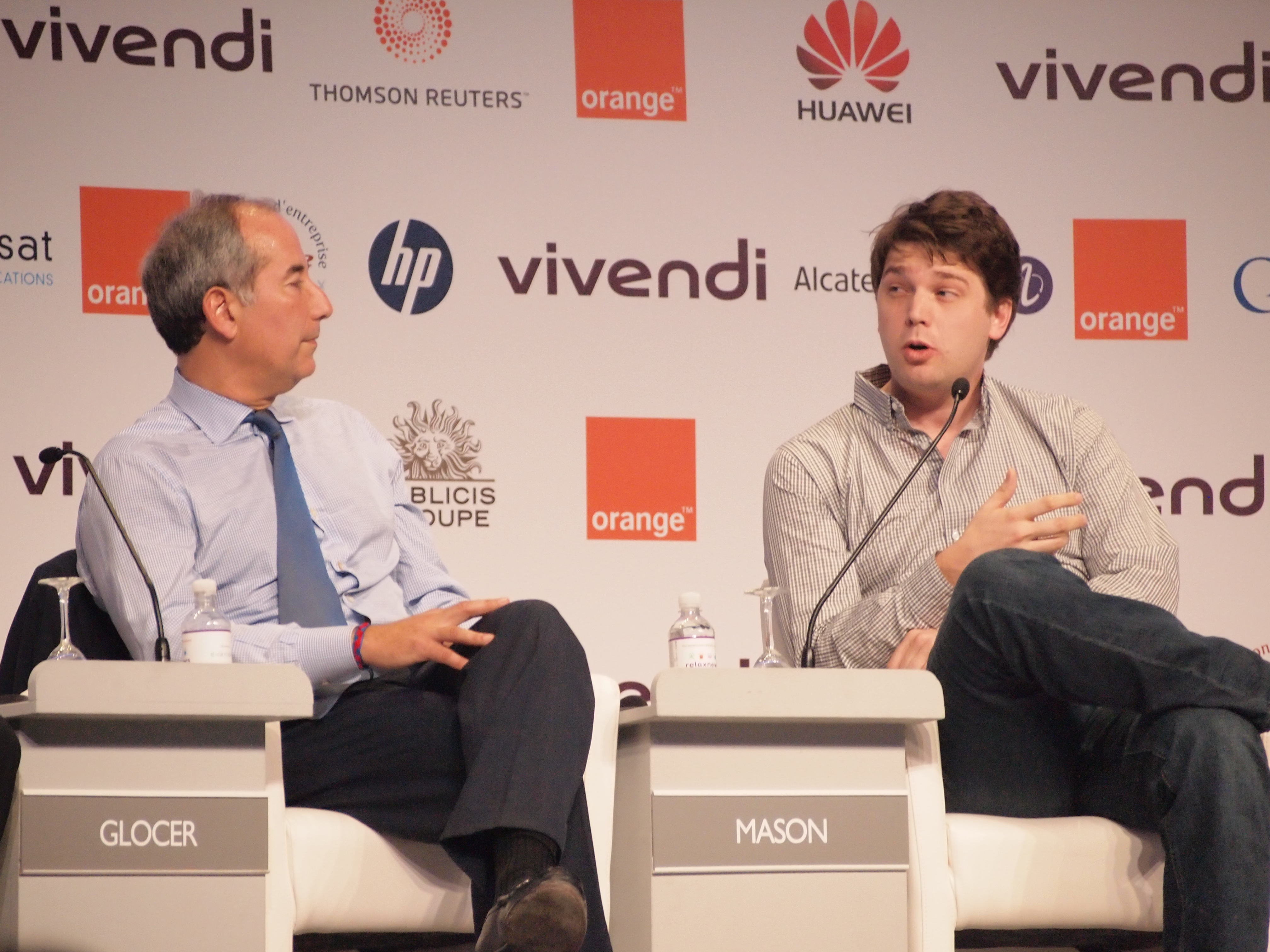 Tom Glocer and Andrew Mason seated during a discussion at the E-G8 Forum in Paris in 2011