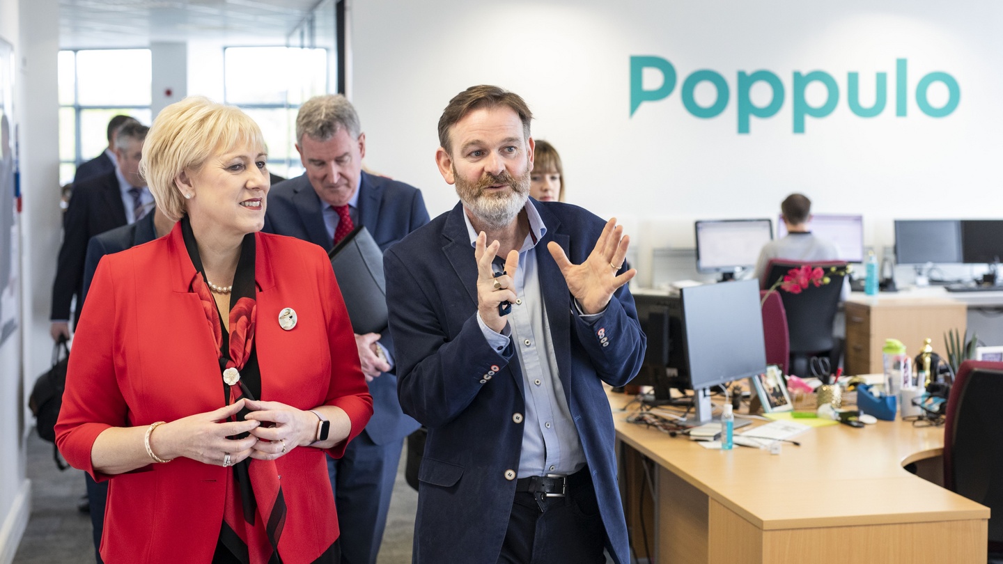 Andrew O’Shaughnessy gestures while showing Heather Humphreys around Poppulo’s Cork office in May 2019.
