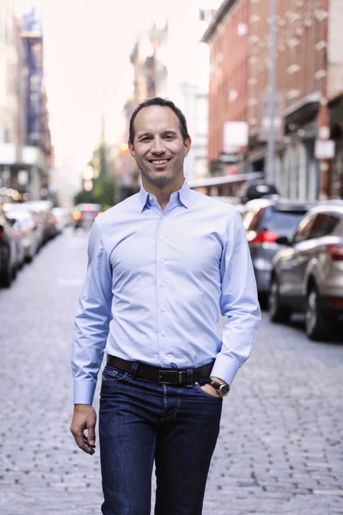 Andrew Paradise walking along a cobblestone street