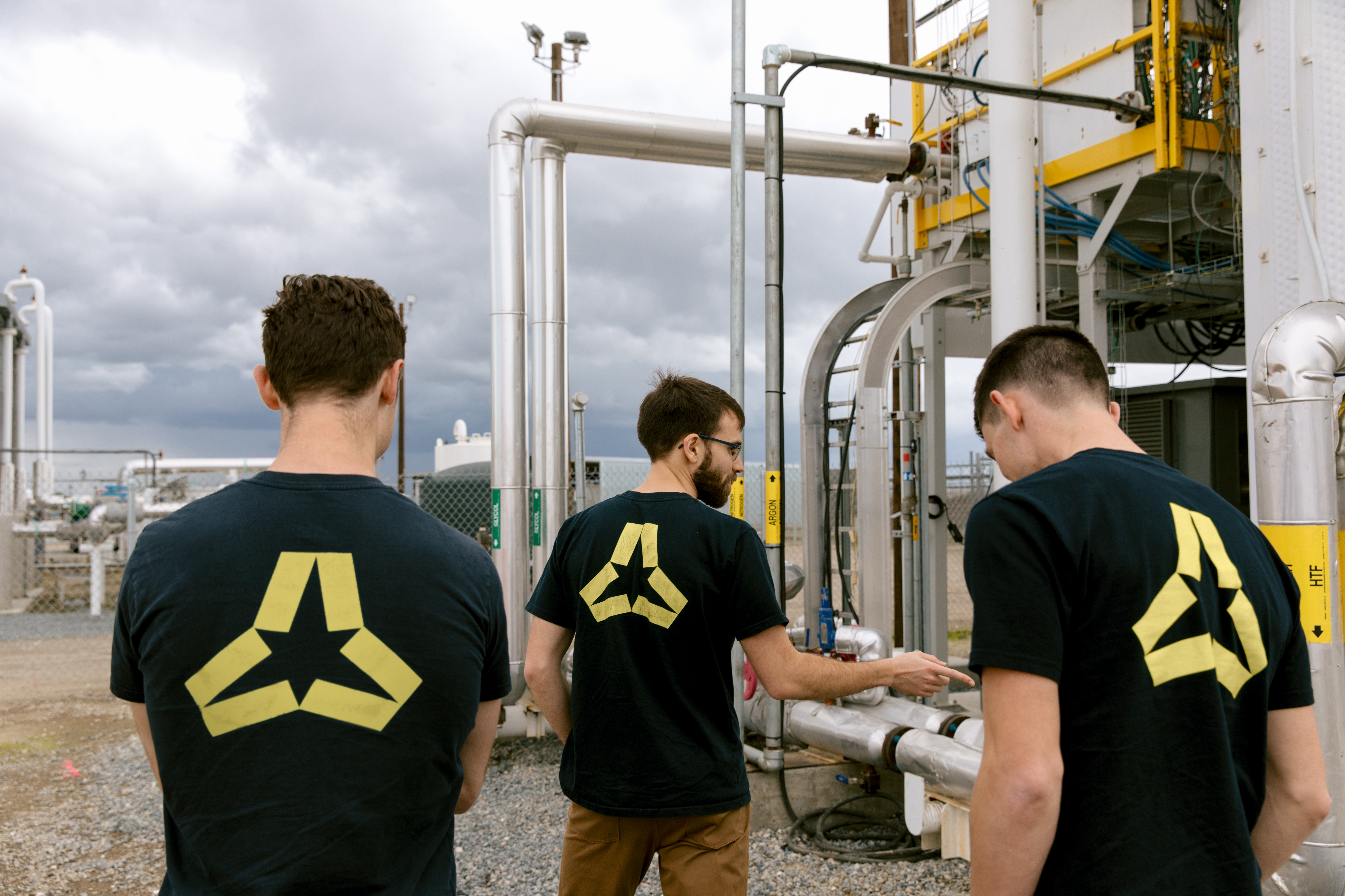 Andrew Ponec and Antora Energy co-founders inspect equipment at an industrial site