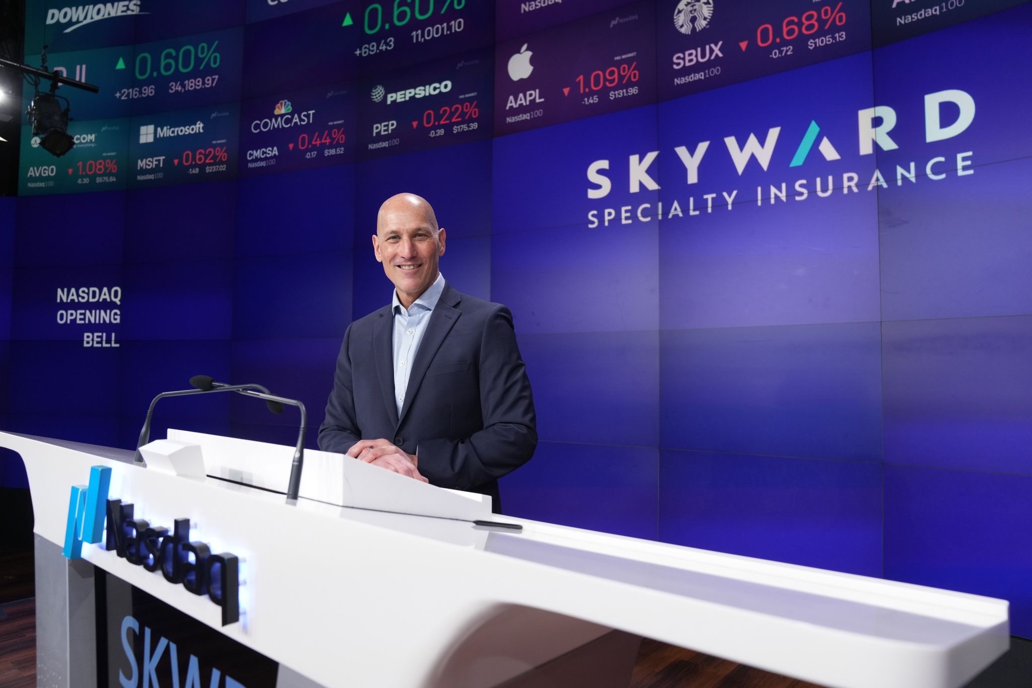Andrew Robinson at the Nasdaq opening bell podium