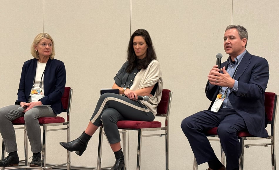 Andrew Shakman speaking with two fellow panelists at GreenBiz 26
