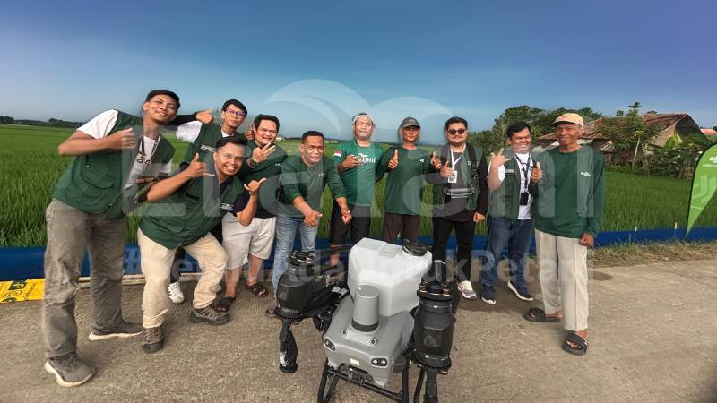 Eratani team and partners beside a rice field with agricultural drone equipment