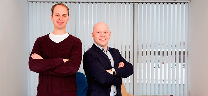 Ivideon co-founders Vladimir Eremeev and Andrew Yudnikov standing in an early office
