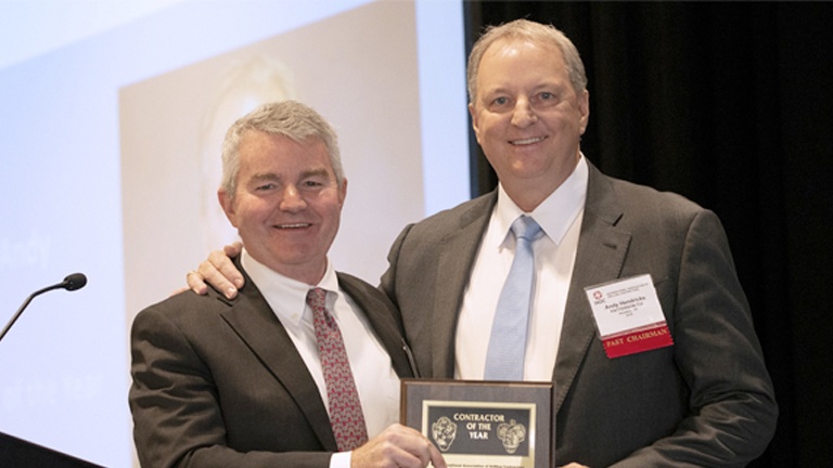 Andy Hendricks, right, receiving the 2021 IADC Contractor of the Year award from Clay Williams