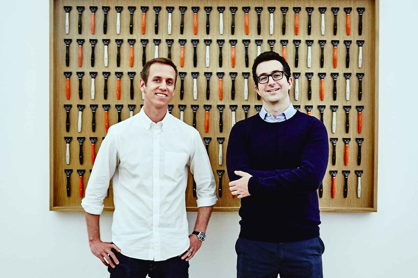 Harry’s co-founders Andy Katz-Mayfield and Jeff Raider standing beside a display of colourful razor handles