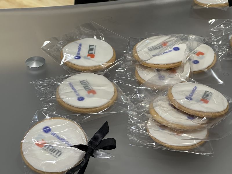 Individually wrapped cookies decorated with the MIM and GE HealthCare brands.