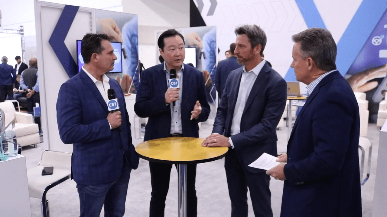 Andy Park, second from left, discussing CarNow at the 2022 NADA Show with Tim Cox, Michael Seeman and a CBT News interviewer