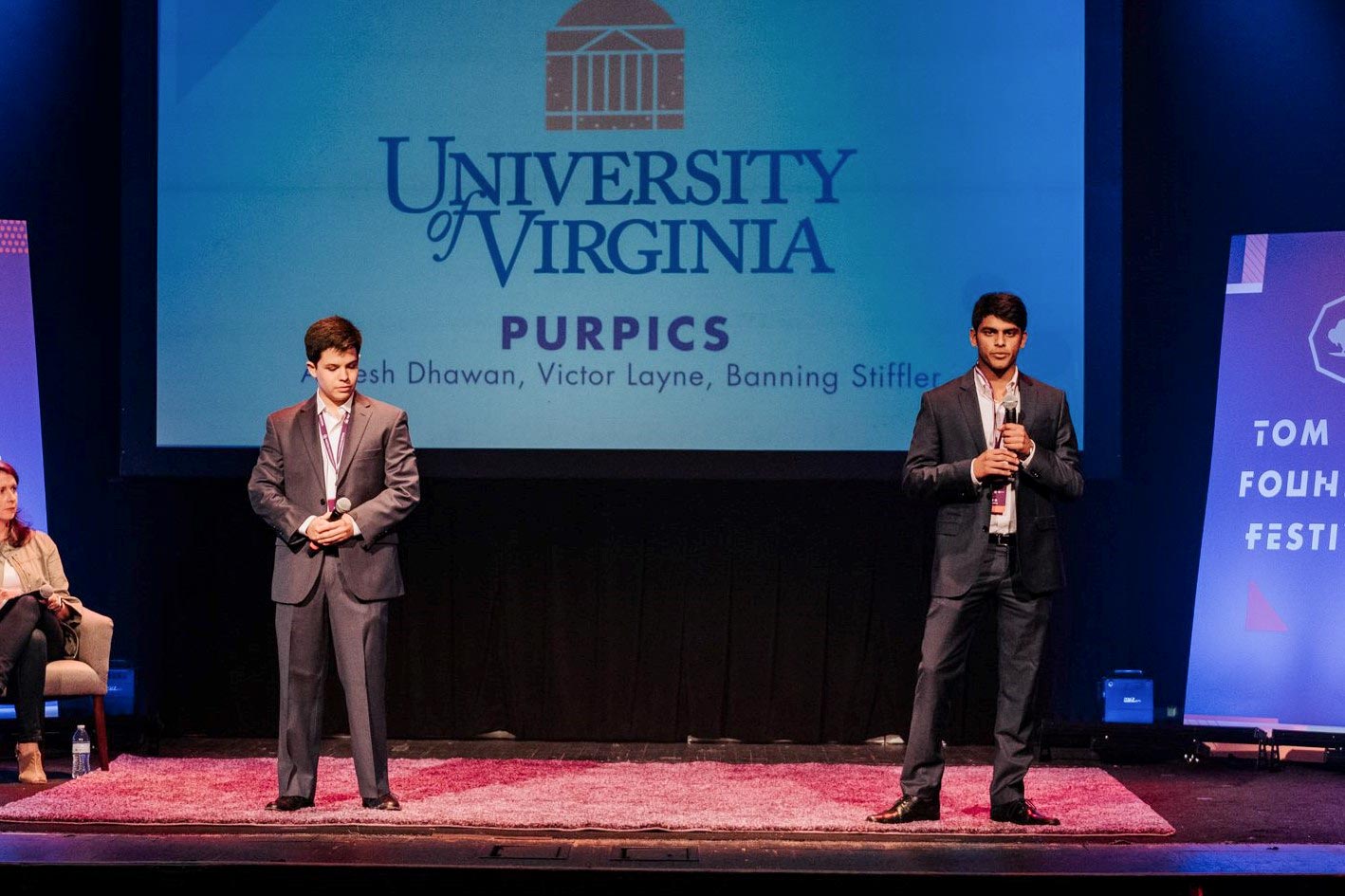 Victor Layne, left, and Aneesh Dhawan presenting PurPics on a stage