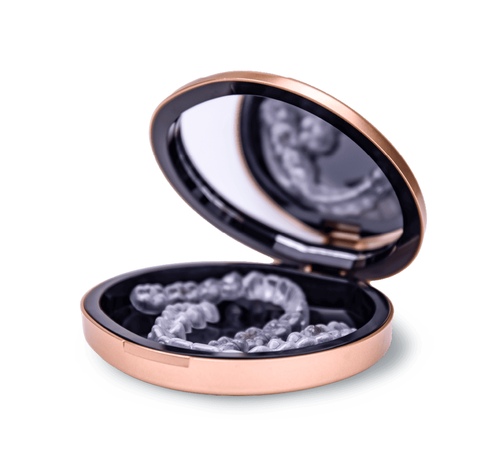 Angel Aligner Pro clear trays in an open rose-gold carrying case