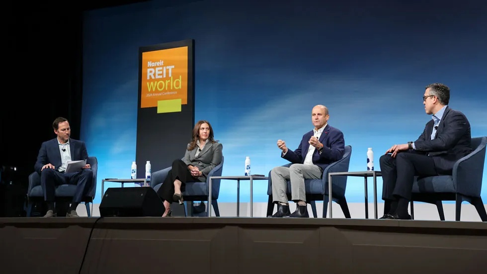 Angela Aman, second from left, seated on a REITworld conference panel with Conor Flynn, Edward Pitoniak and Andrew Power