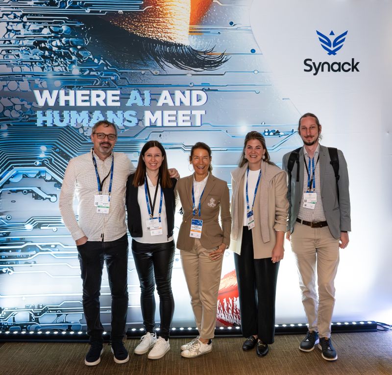 Angela Heindl-Schober with attendees in front of Synack's Where AI and Humans Meet display at RSAC 2026
