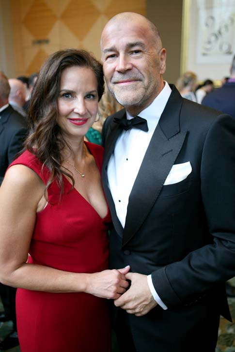 Angela MacInnis in a red evening dress with Calvin MacInnis at a Vancouver fundraiser