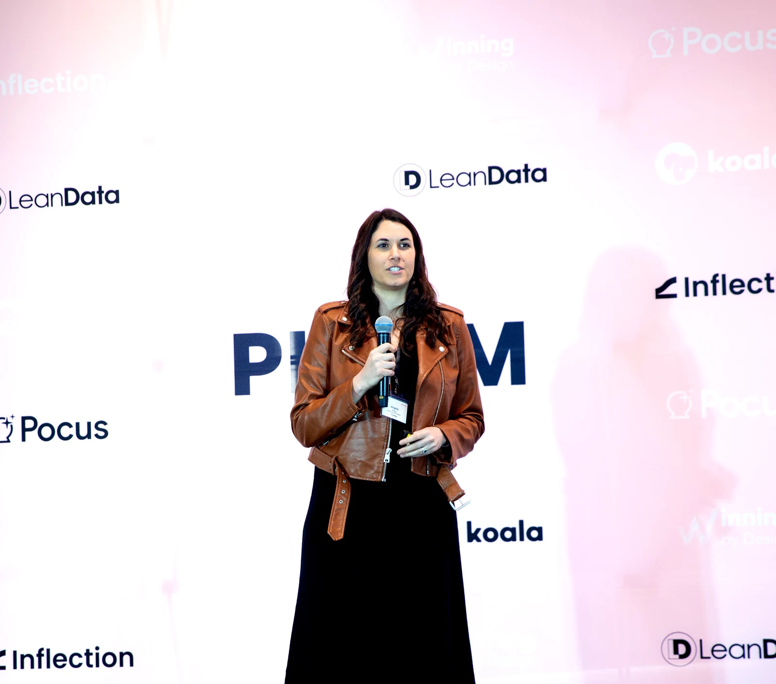 Angela Winegar speaking onstage at the 2024 PLGTM Expo