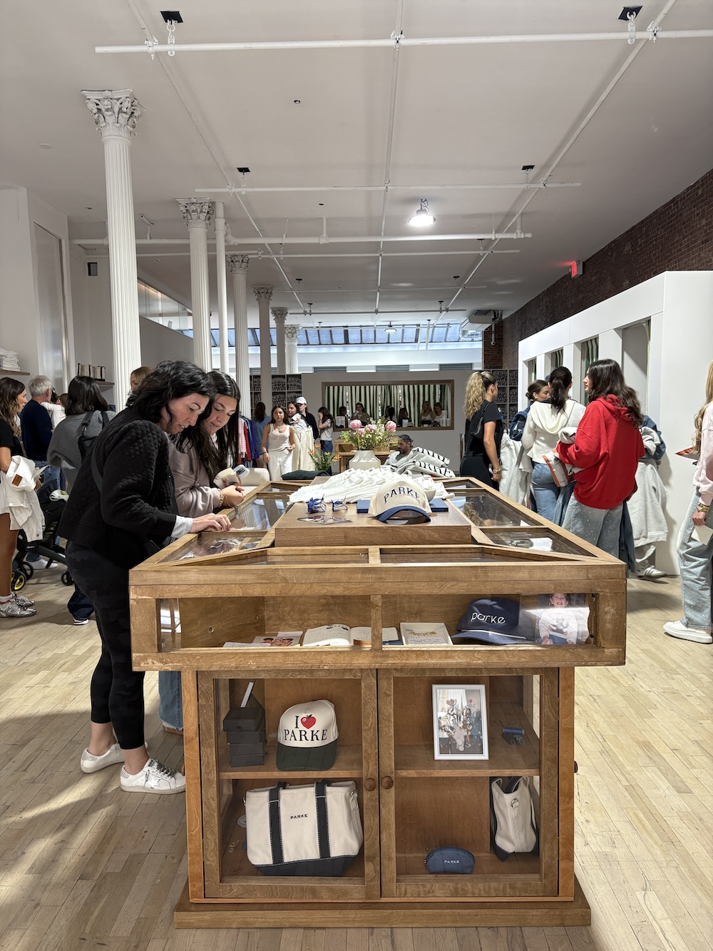 Shoppers browsing caps, bags and archival displays at the Parke pop-up at 21Greene