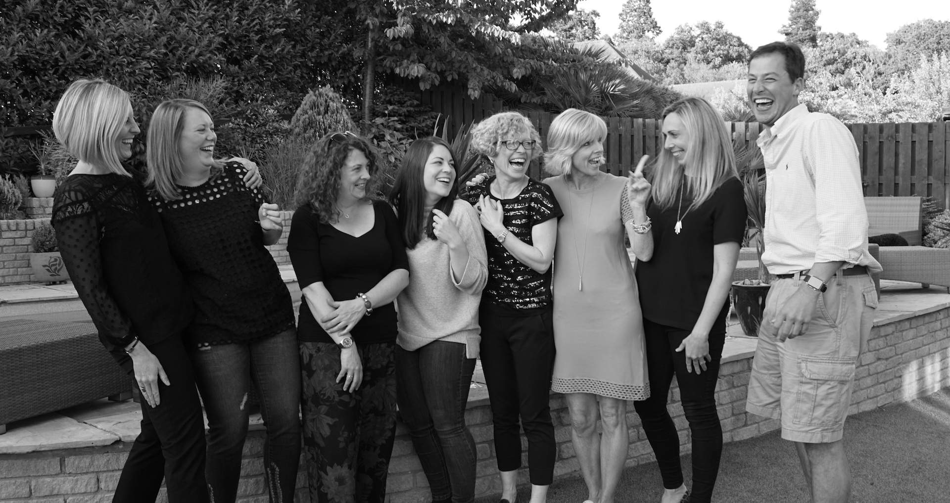 Members of The Difference Collective laughing together outdoors