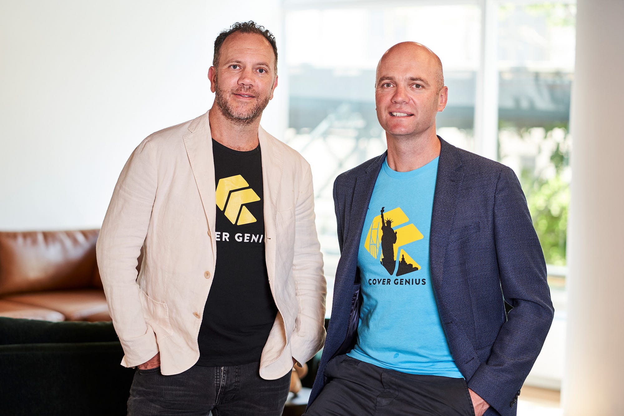Cover Genius co-founders Chris Bayley, left, and Angus McDonald, right, standing together in an office