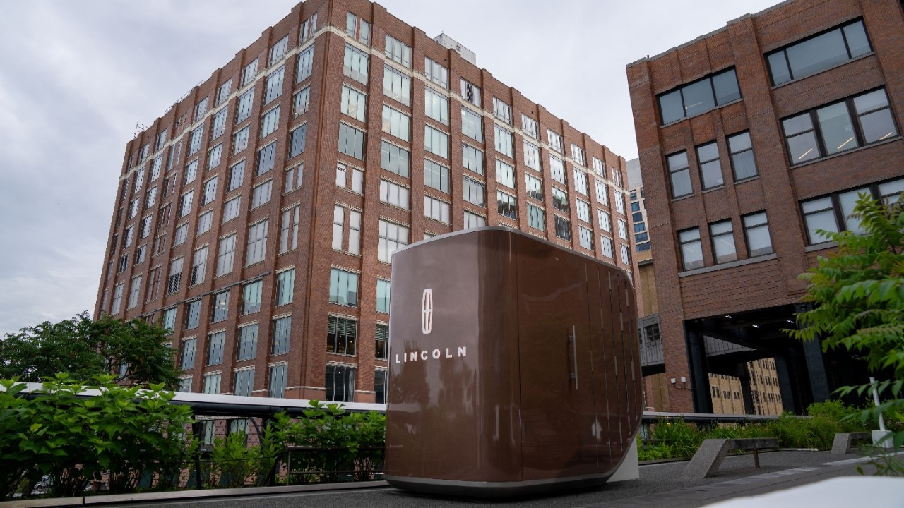 The Sanctuary by Lincoln Rejuvenate installation on New York's High Line between brick buildings