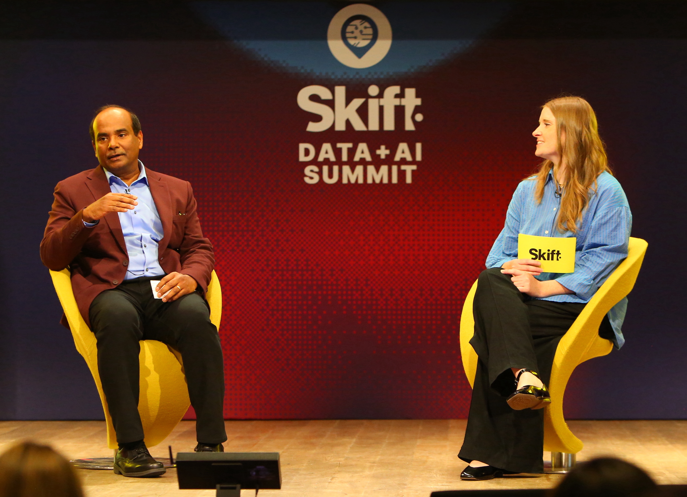 Anil Aggarwal speaking with moderator Alison McCarthy onstage at the Skift Data and AI Summit in 2026