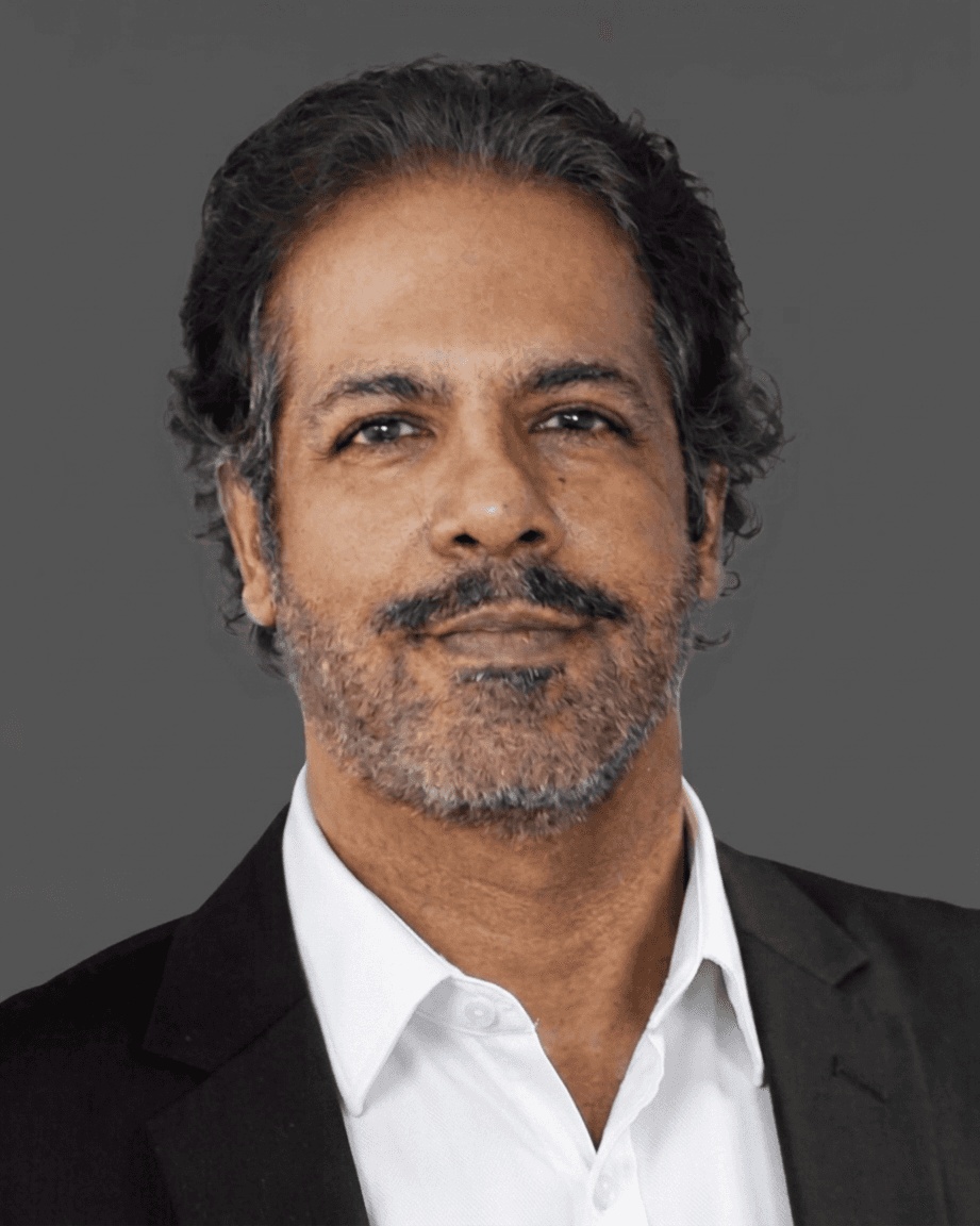 Anil Kottoor in a dark jacket and open-collar white shirt