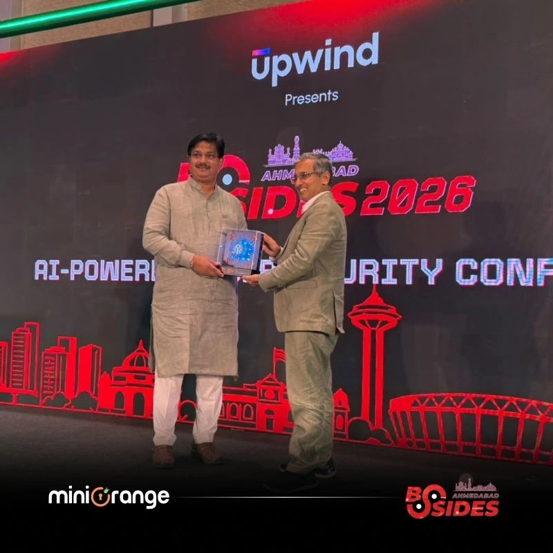 Anirban Mukherji, on the right, receiving a memento onstage at BSides Ahmedabad 2026