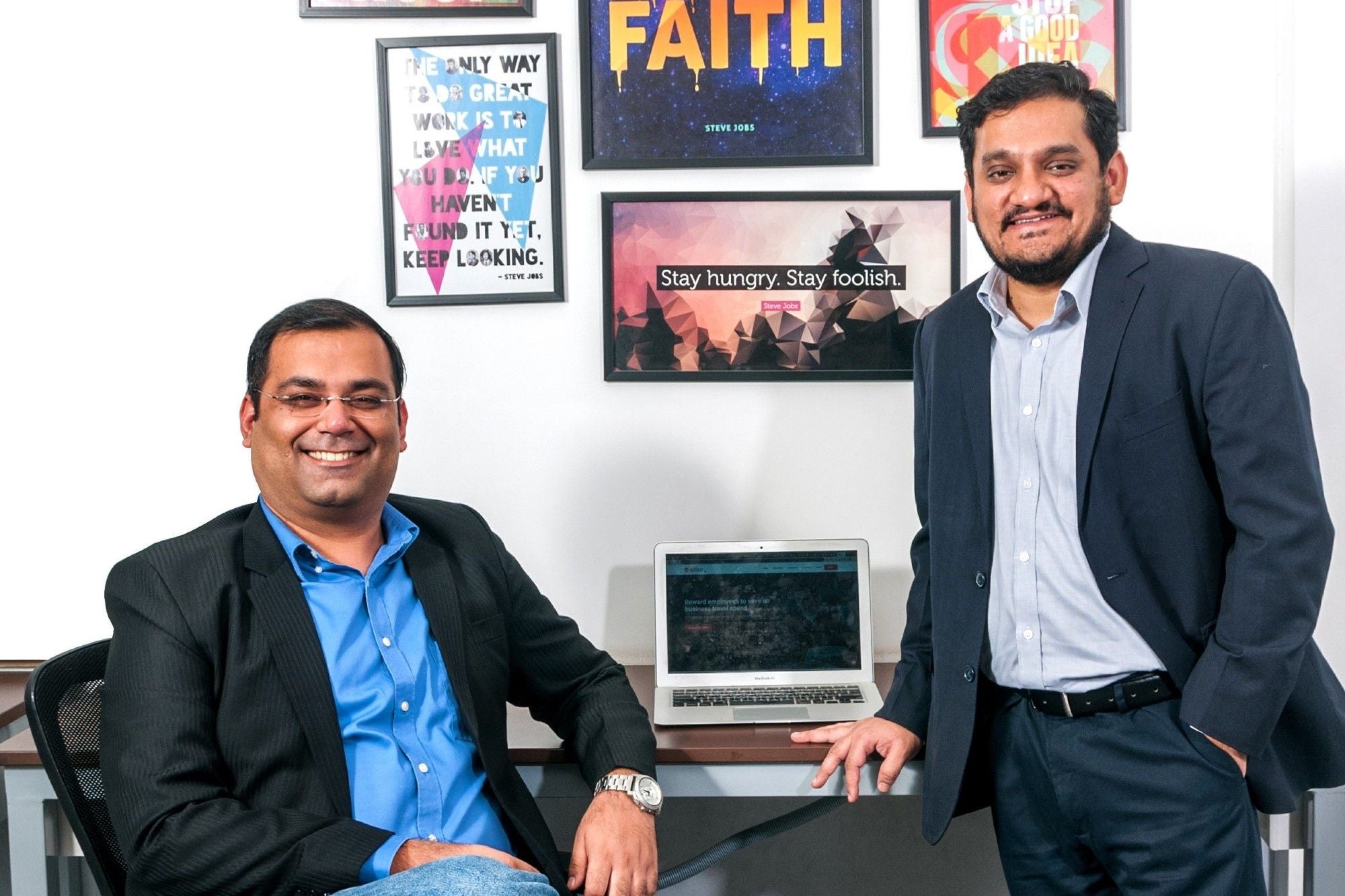 ITILITE co-founders Anish Khadiya and Mayank Kukreja in an office with framed motivational posters