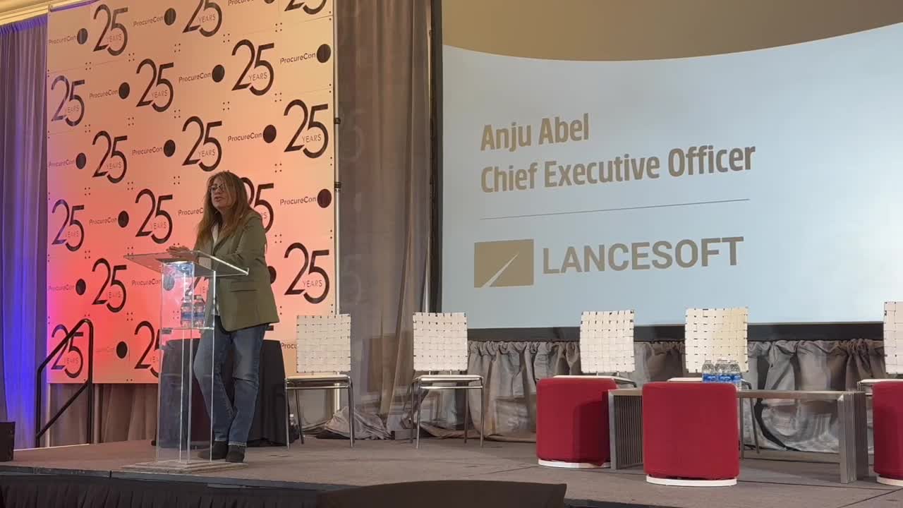 Anju Abel speaking at a lectern during ProcureCon's 25th-anniversary conference, with her name and LanceSoft title projected behind her