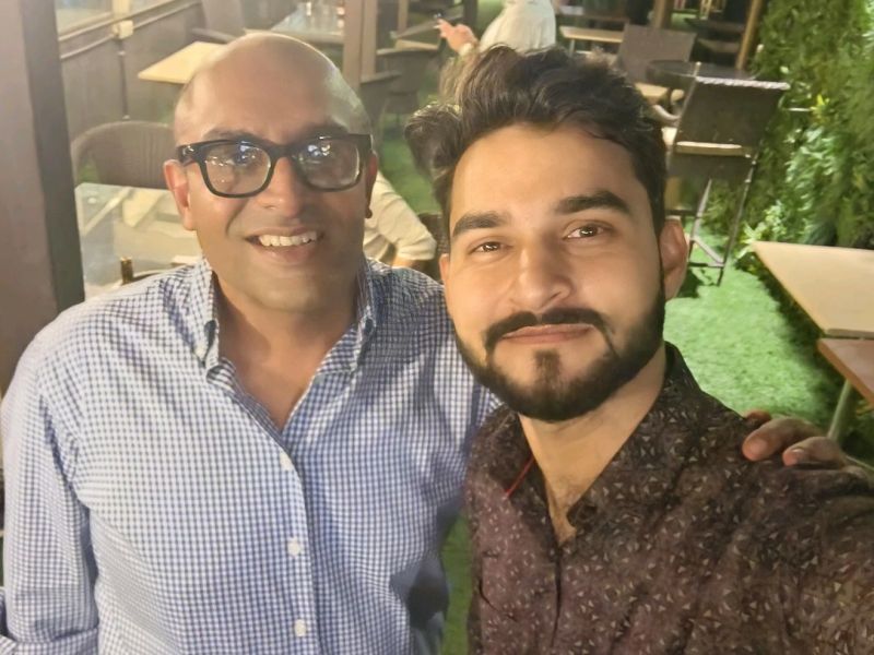 Ankit Sheoran, left, smiling alongside Aakashdeep Sharma at an evening gathering