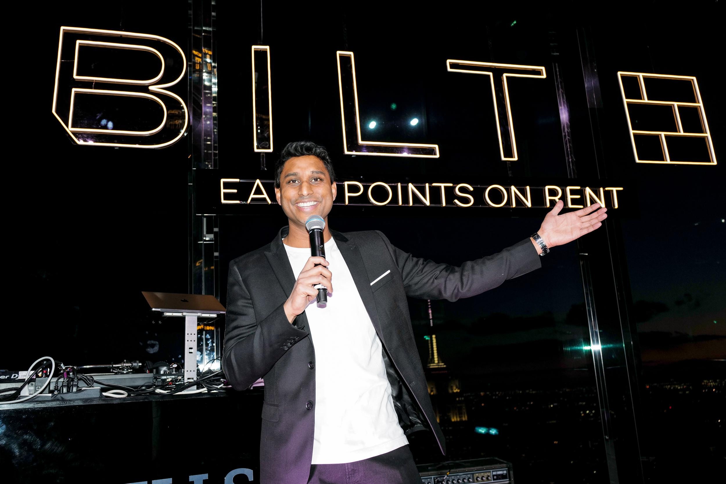 Ankur Jain speaking in front of a Bilt sign at a company event