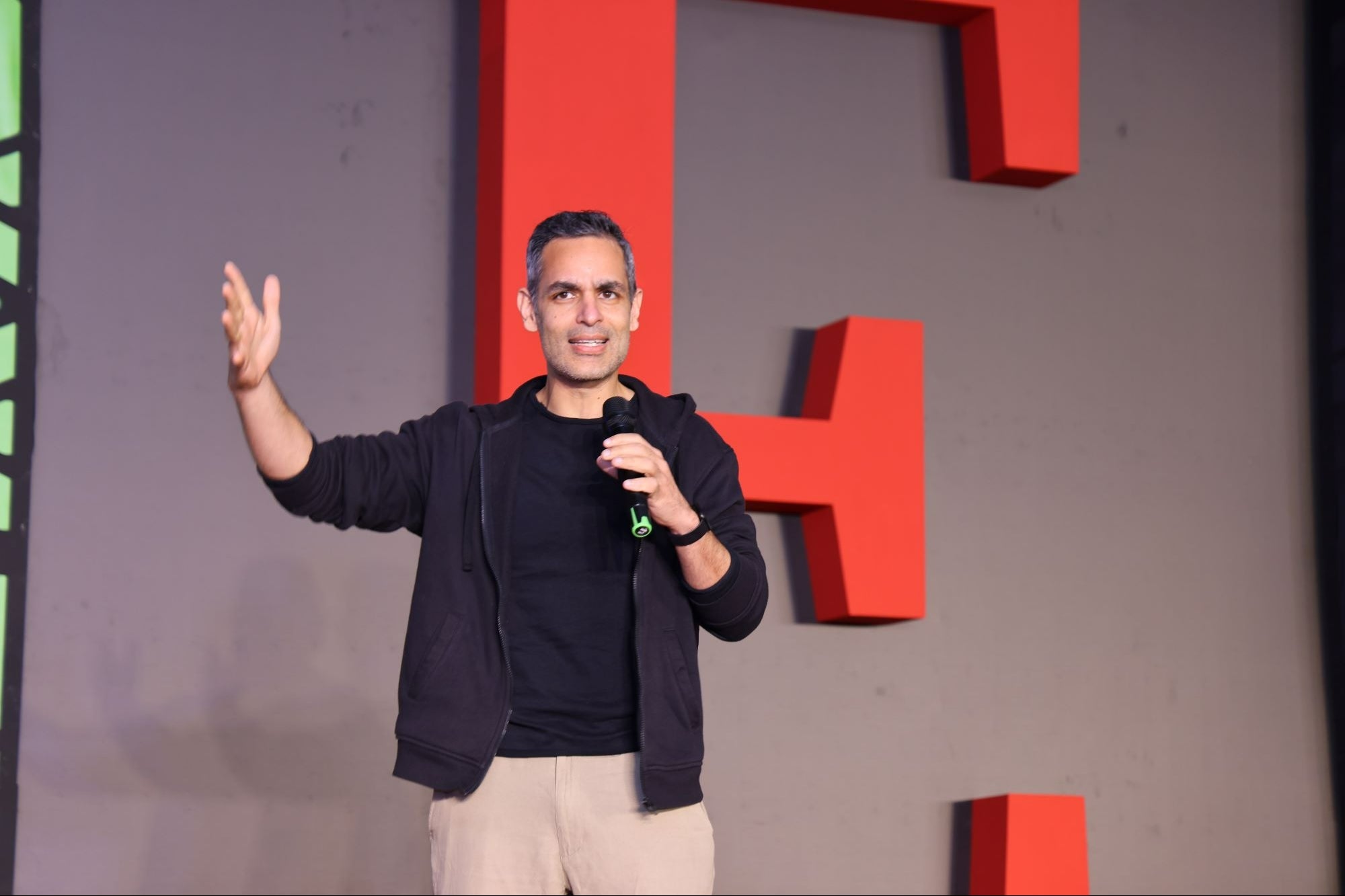 Ankur Warikoo speaking with a microphone at Entrepreneur India's Tech and Innovation Summit in 2025