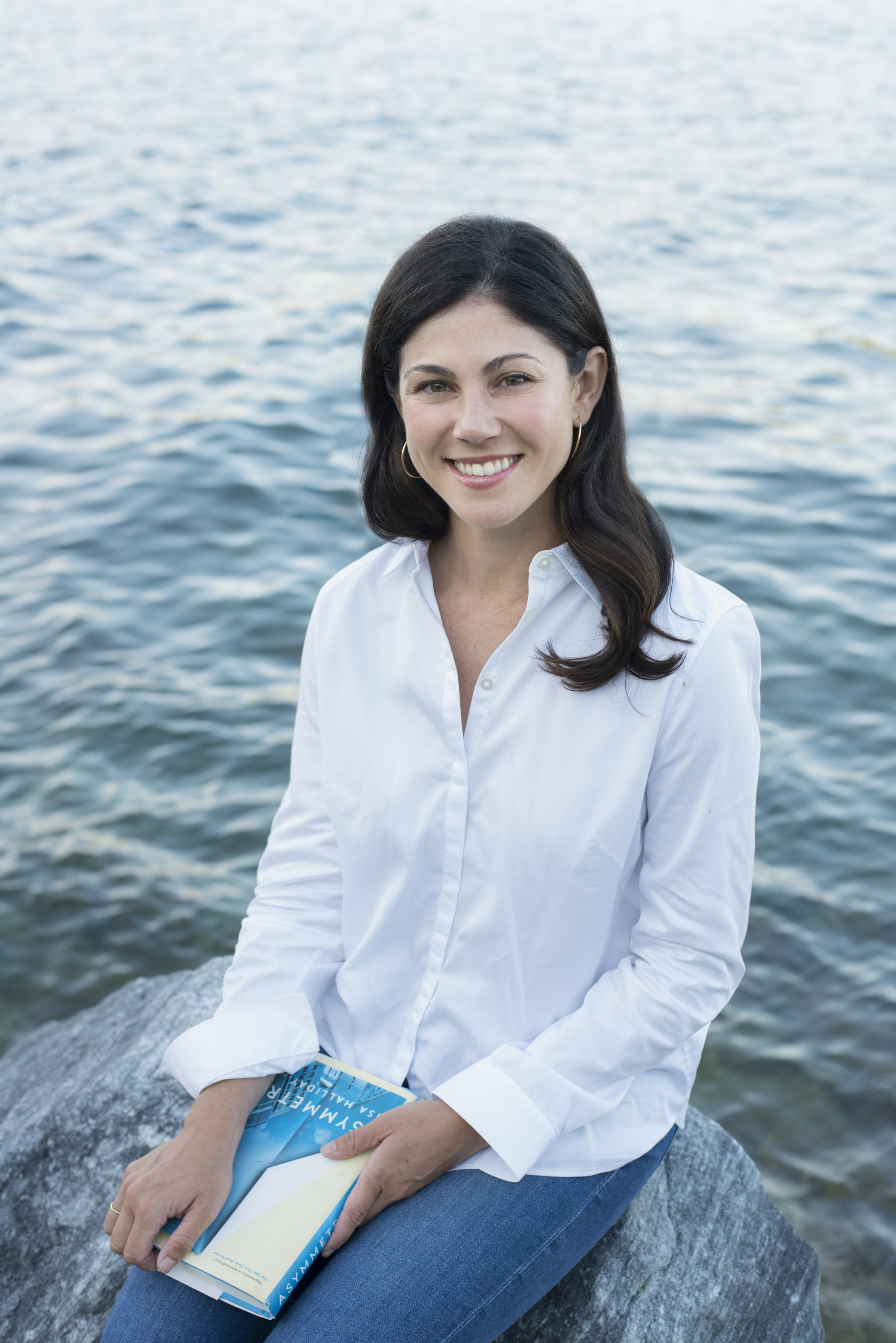 Anna Ford, co-founder and CEO of Bookclubs, photographed by the water holding a book