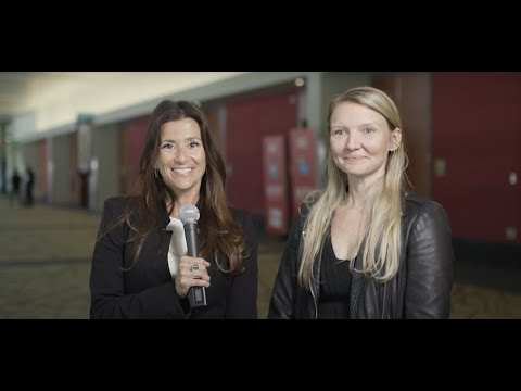 Anna Lindow standing with an interviewer at the ViVE 2022 conference in Miami Beach