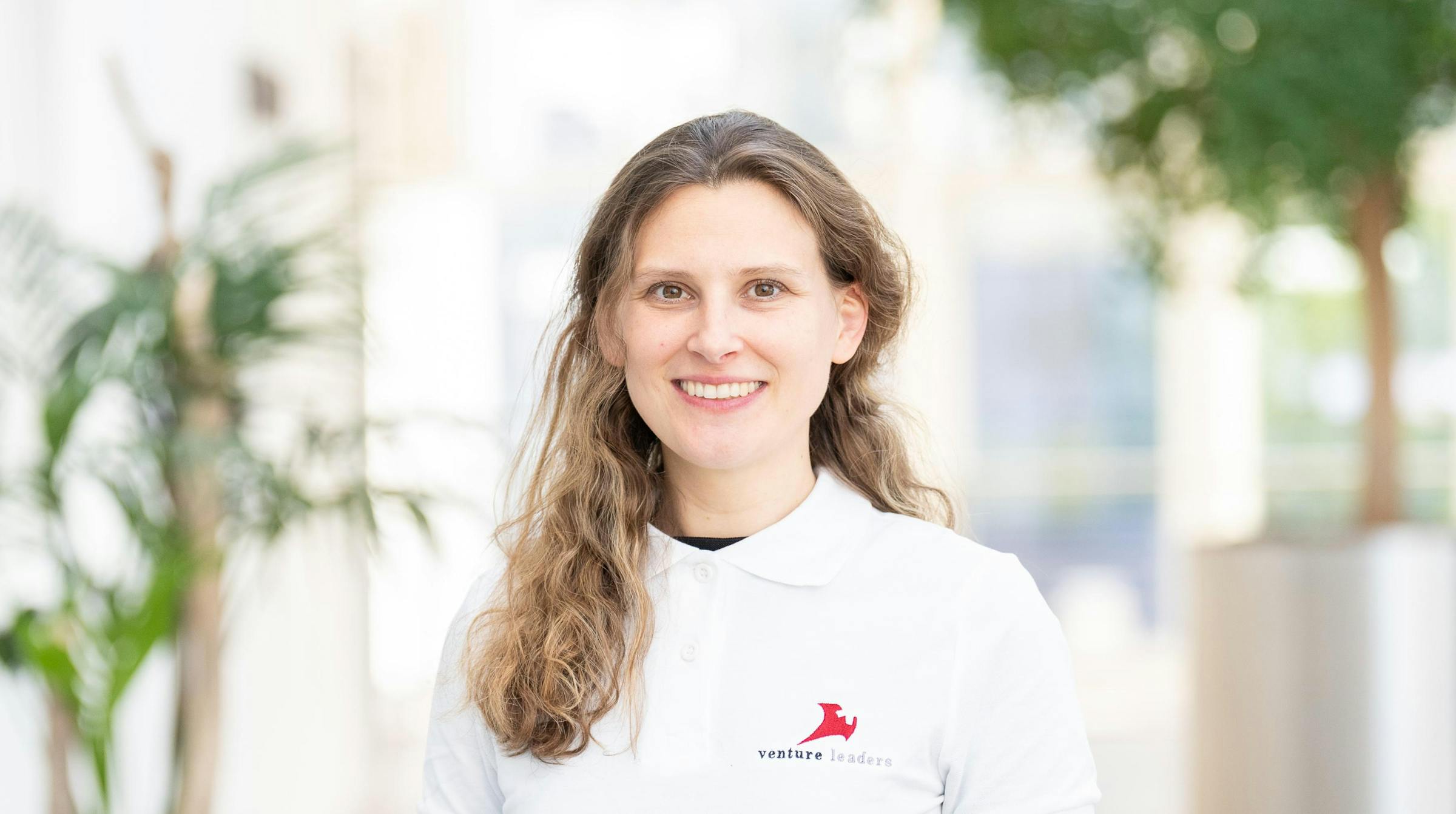 Anna-Luisa Schaffgotsch wearing a Venture Leaders polo shirt in a bright indoor setting