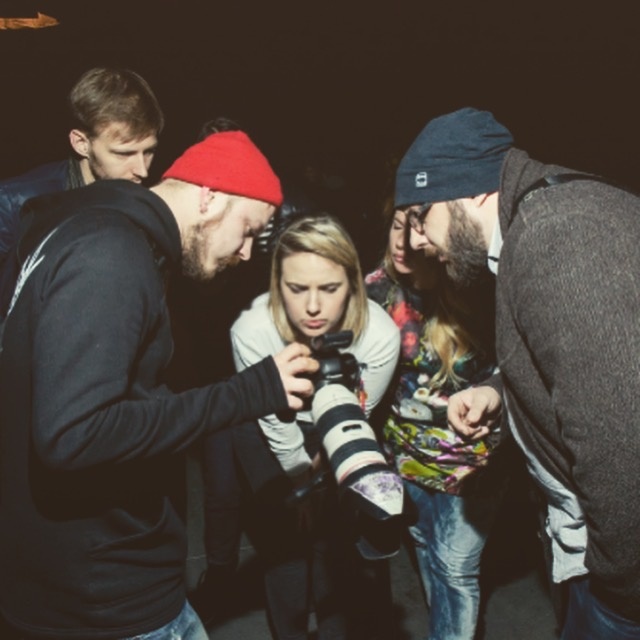 Anna Pagava and a production crew examine a camera together