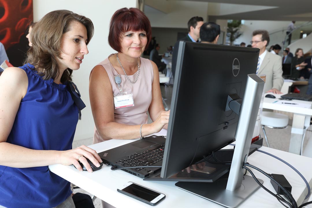 Two attendees examining a software demonstration at Papyrus Open House 2018
