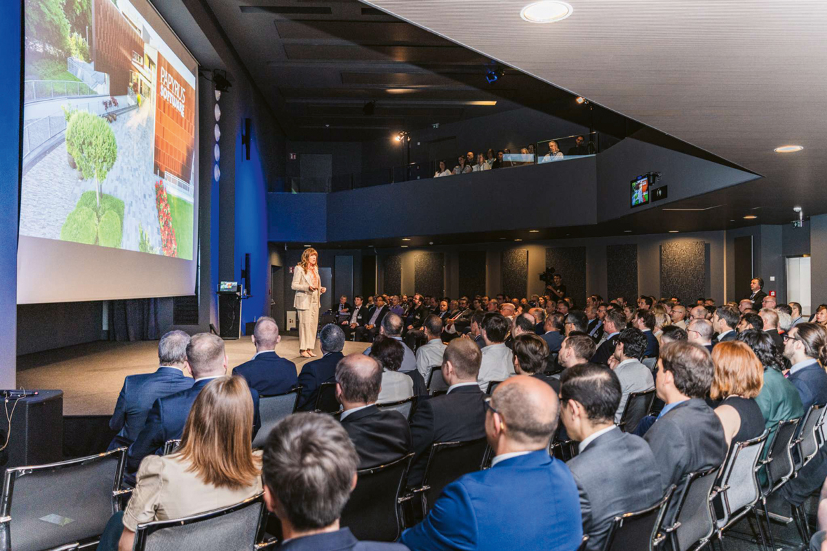 Annemarie Pucher speaking on stage to an audience at a Papyrus corporate event