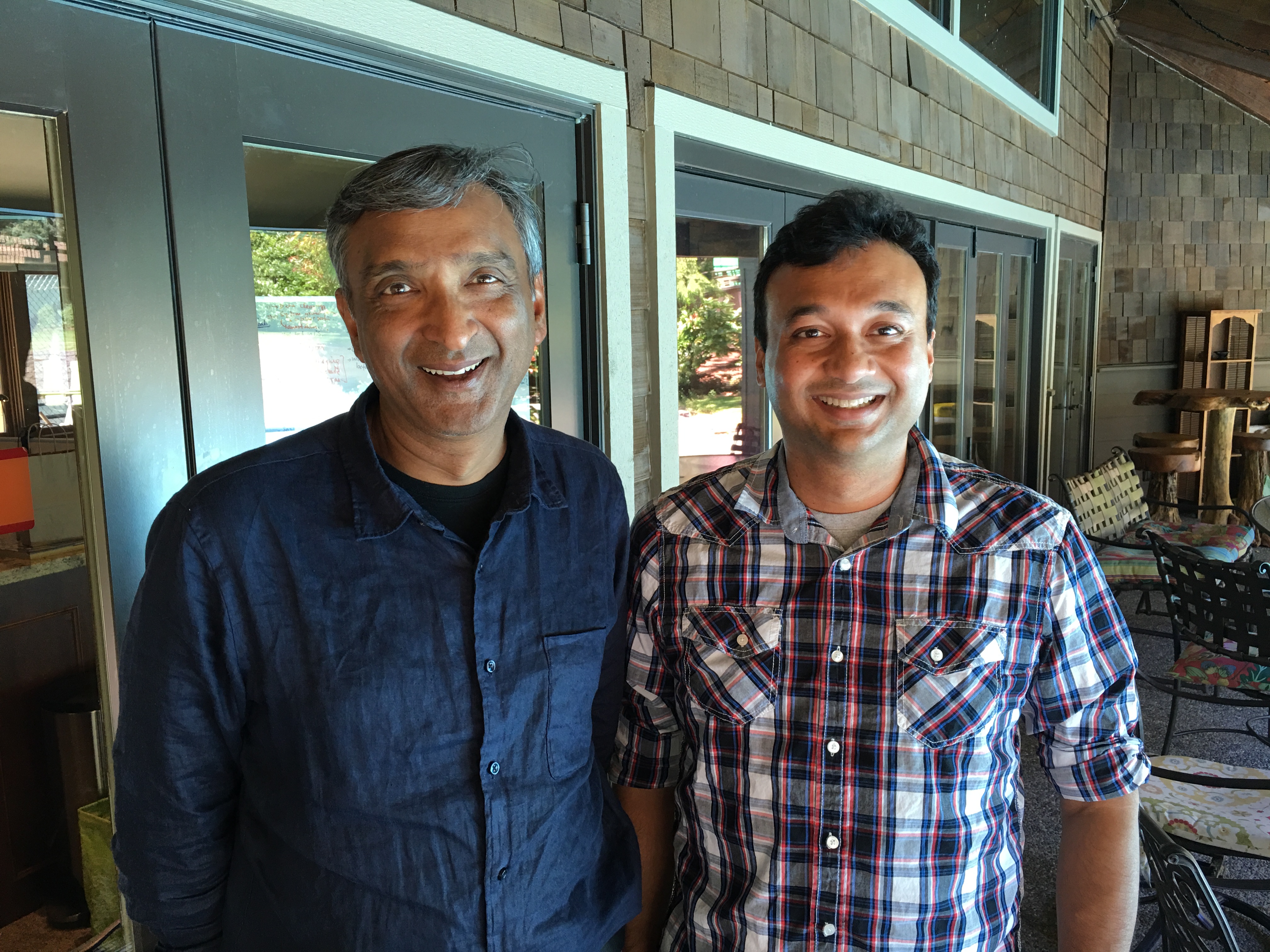 Anoop Gupta, left, and Aravind Bala smiling outside Gupta’s Bellevue home in 2016