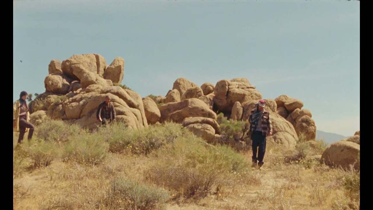 People crossing a rocky desert landscape in Anoria's launch film