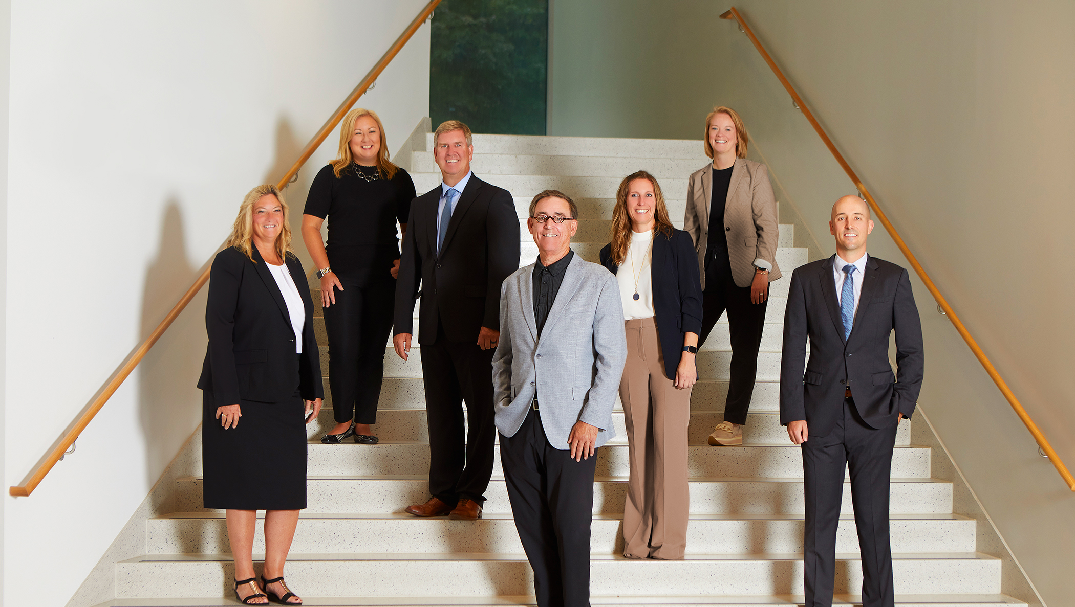 Ansay leadership group standing together on an indoor staircase