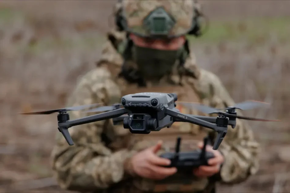 A small drone in flight against a pale sky