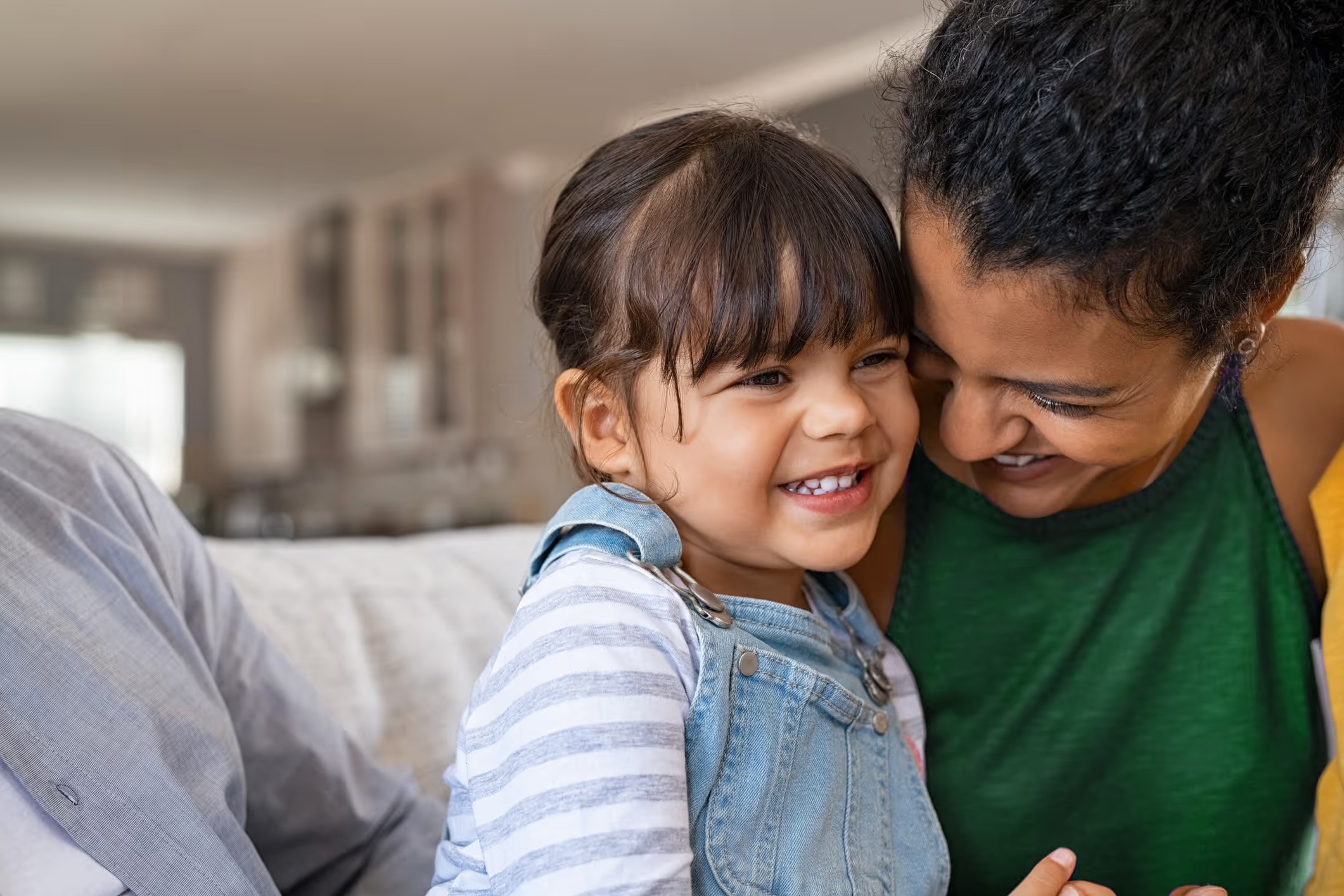 A child and caregiver taking part in a virtual learning session at home