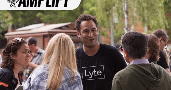 Ant Taylor wearing a Lyte shirt and speaking with a small group outdoors