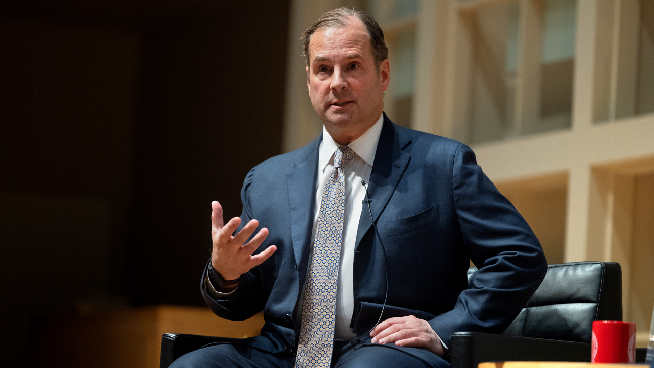 Anthony Capuano speaking at Cornell’s 2023 Hatfield Lecture, seated and gesturing with one hand