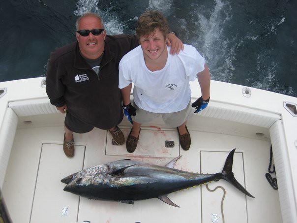 Anthony DiPaolo, left, beside another angler and a tuna on a boat