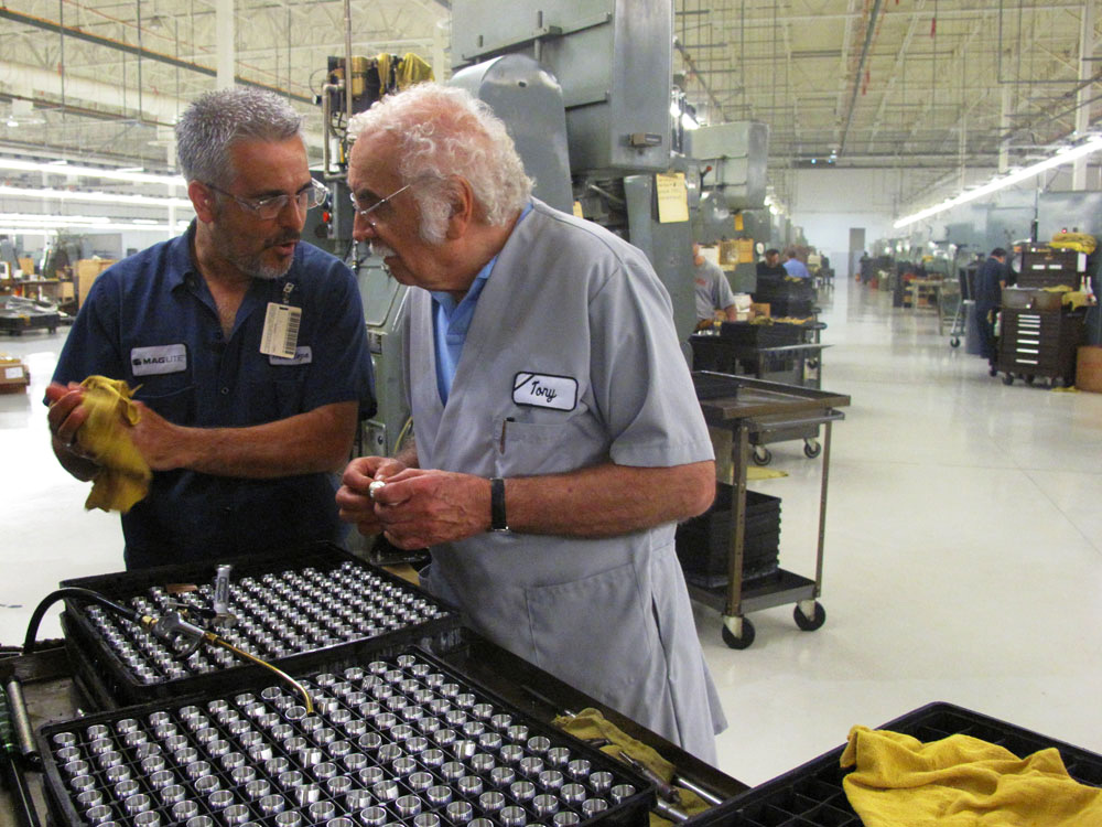 Tony Maglica, right, inspecting parts beside a colleague on the Ontario factory floor