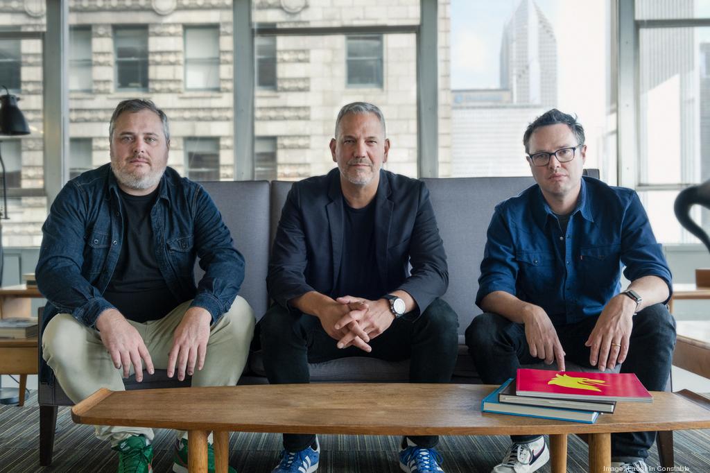 Jon Laughlin, Anthony Romano and Pat Laughlin seated together in an office